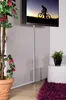 A TV screen mounted on a wall with a cable management system, next to a plant and a side table. Podgląd zdjęcia produktu