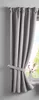 A gray curtain is tied back with a fabric tie and hangs next to a window. Produktbild-Vorschau
