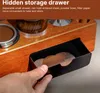 A hand is pulling out a small drawer from a wooden coffee accessory organizer. Náhled obrázku produktu