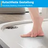 A person's feet are stepping onto a textured shower tray with a drain. Anteprima dell’immagine prodotto