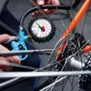A person is using a tire pressure gauge on a bicycle wheel. Náhľad obrázku produktu