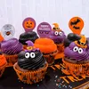 A collection of Halloween-themed cupcakes decorated with frosting, candy eyes, and festive toppers. Náhled obrázku produktu