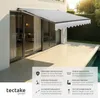 An awning is extended over a patio area next to a sliding glass door and a swimming pool. Náhled obrázku produktu