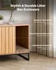 A wooden litter box enclosure with a scratching pad and storage space, shown in a room setting with curtains in the background. Produktbild-Vorschau