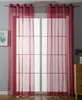 A room with a window covered by sheer red curtains. Produktbild-Vorschau