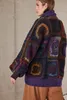 A woman wearing a colorful crocheted cardigan. Produktbild-Vorschau