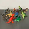 A collection of plastic dinosaur toys arranged on a gray surface with a light gray background. Náhľad obrázku produktu