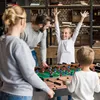 A family is playing foosball in a living room. Náhľad obrázku produktu