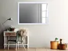 A mirror is displayed above a desk with a chair and decorative items in a room. Produktbild-Vorschau