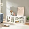A white TV stand with various decorative items and books is shown in a living room setting. Anteprima dell’immagine prodotto
