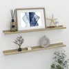 Two white and Sonoma oak effect floating shelves mounted on a white wall, decorated with various items. Náhled obrázku produktu