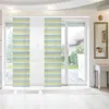 Panel curtains with a striped pattern are shown in a room with large sliding glass doors leading to a garden. Produktbild-Vorschau