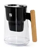 A clear water pitcher with a black filter housing and a wooden handle. Náhľad obrázku produktu