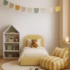 A child's bedroom with a bed, bookshelf, and beanbag chair. Produktbild-Vorschau