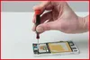A hand is using a screwdriver to work on the internal components of a disassembled smartphone. Produktbild-Vorschau