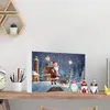 A Christmas advent calendar with a winter scene featuring Santa Claus, a lighthouse, and reindeer, placed on a wooden shelf with decorative gnomes and a clock. Produktbild-Vorschau