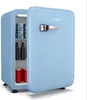 A light blue retro mini-fridge with its door open, showing several items inside. The fridge is on a white background. Produktbild-Vorschau