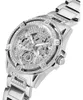 A close-up, angled shot of a silver Guess watch with crystal embellishments. Voir les images du produit