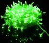 A close-up shot of a tangled ball of green LED string lights on a reflective black surface. Anteprima dell’immagine prodotto