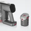 A close-up studio shot of a cordless vacuum cleaner's main unit and its detachable battery pack, against a gradient background. Produktbild-Vorschau