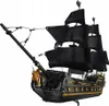 A black and gold pirate ship model with black sails, set against a white background. Podgląd zdjęcia produktu