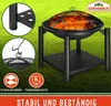 A fire pit with a lid and a shelf, set on a grassy lawn. Produktbild-Vorschau