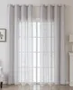 A pair of light gray sheer curtains hanging over a window. Produktbild-Vorschau