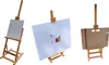 Three different views of a wooden easel with canvases. Produktbild-Vorschau