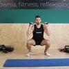 A man is performing a squat exercise with resistance bands in a gym. Náhled obrázku produktu