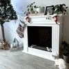A festive living room scene with a fireplace, Christmas tree, and decorations. Podgląd zdjęcia produktu