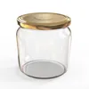 A clear, studio shot of an empty glass jar with a gold screw-on lid, presented on a white background. Voir les images du produit