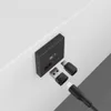 A black USB-C adapter and USB-A adapter are shown next to a black charging port with a battery indicator. Produktbild-Vorschau