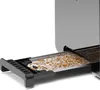 A close-up view of a toaster's crumb tray, filled with crumbs. Produktbild-Vorschau