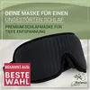 A black sleep mask is shown on a textured white background with green accents and text overlays. Anteprima dell’immagine prodotto
