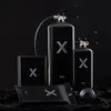 A product shot of multiple black fire extinguishers and accessories on a black background. Voir les images du produit