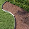 A garden path bordered by grass and a hedge. Produktbild-Vorschau