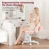 A woman is sitting on a pink office chair in front of a white vanity table, applying makeup. Produktbild-Vorschau