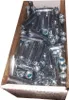 A cardboard box filled with metal fasteners. Produktbild-Vorschau