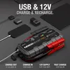 A NOCO Boost GB150 jump starter is shown with various electronic devices and charging cables, illustrating its charging capabilities. Produktbild-Vorschau