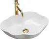 A white oval sink with a gold faucet and drain. Produktbild-Vorschau