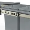 A close-up view of a pull-out trash bin system with two compartments, showing the telescopic rails and the gray bins. Náhľad obrázku produktu