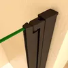 A close-up view of a dark gray shower enclosure hinge mechanism with a green glass panel inserted. Produktbild-Vorschau