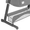 A close-up view of the gray frame and storage basket of a baby crib or bassinet. Anteprima dell’immagine prodotto