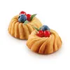 Two mini bundt cakes topped with berries and leaves on a white background. Produktbild-Vorschau