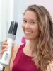 A woman is holding a hair dryer with a comb attachment. Náhled obrázku produktu