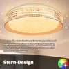 A close-up view of a modern ceiling light with a star-like pattern and a woven texture around the edge, set against a ceiling. Produktbild-Vorschau