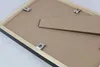 The back of a picture frame is shown, highlighting the fasteners and stand. Produktbild-Vorschau