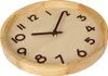 A close-up view of a round wooden wall clock with dark numbers and hands. Produktbild-Vorschau