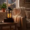 A cozy indoor scene with a lantern on a table next to a couch. Produktbild-Vorschau