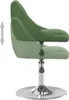 A green velvet chair with adjustable height. Produktbild-Vorschau